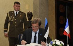 Mr. Bernard Kouchner signs the official guest book.