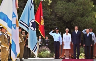 President Toomas Hendrik Ilves, Mrs. Evelin Ilves and Israeli President Shimon Peres (right), listen to national anthems at the presidential compound in Jerusalem during an official welcome ceremony.