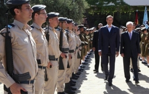 Israeli President Shimon Peres (right) and President Ilves review a military honor guard during a welcoming ceremony at the presidential compound in Jerusalem.
