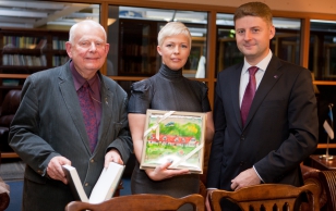 Mr. Otto Kubo, Research Specialist of Kalev Chocolate Factory, Otto Kubo, Mrs. Evelin Ilves, and Mr. Kaido Kaare, CEO. Kalev gave Mrs. Evelin Ilves a piece of marzipan confectionery, featuring Ärma Farm