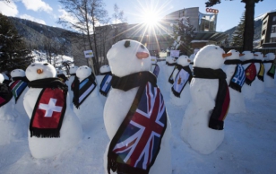 The sun shines over snowmen representing the countries around the world during an exhibition from the NGO ''Action2015'' on the sideline of the 45th Annual Meeting of the World Economic Forum in Davos under the overarching theme ''The New Global Context''